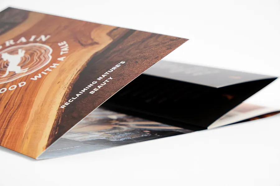 A custom brochure printed with Reclaiming Nature's Beauty and laying on its side showing a accordion fold.