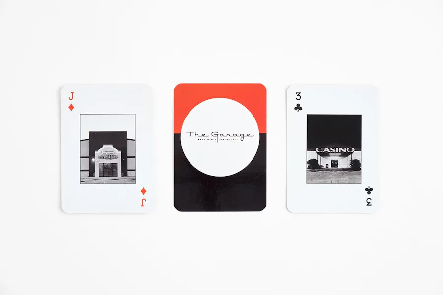 Three custom playing cards lined up in a row printed with The Garage and images of casinos.