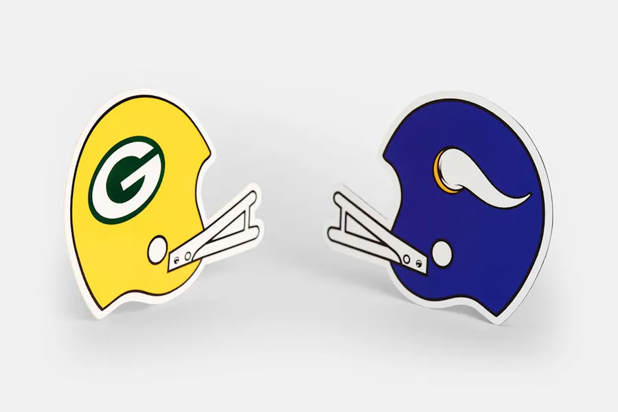 Two custom magnets in the shape of football helmets, one with a Packers design and one with a Vikings design.