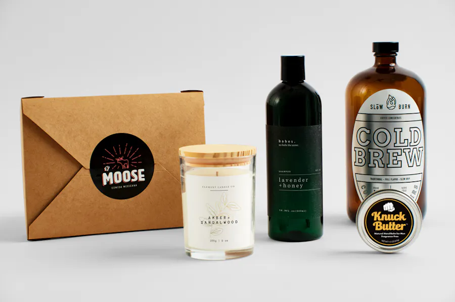 A takeout box, candle, shampoo bottle, cold brew and moisturizer container with custom labels.