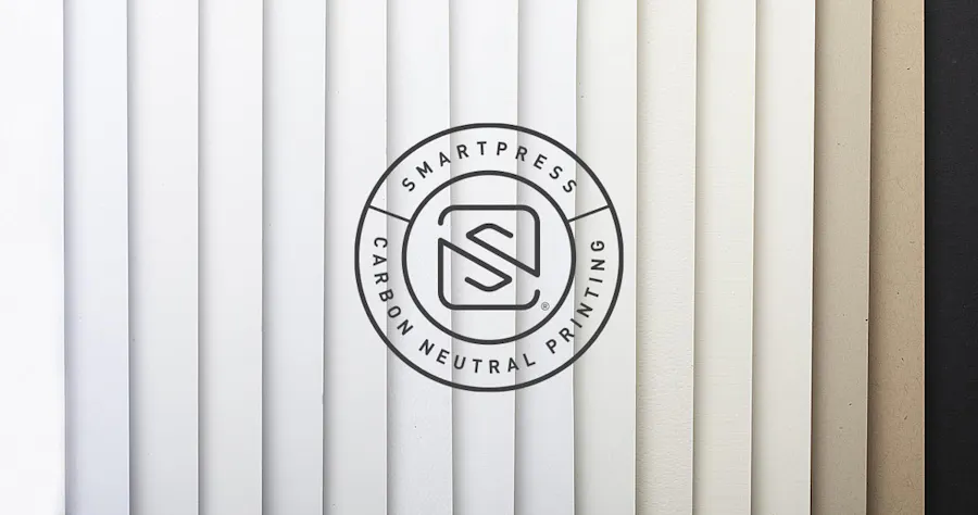 The Smartpress Carbon Neutral Printing logo over fanned-out paper stocks with neutral colors from white to black.