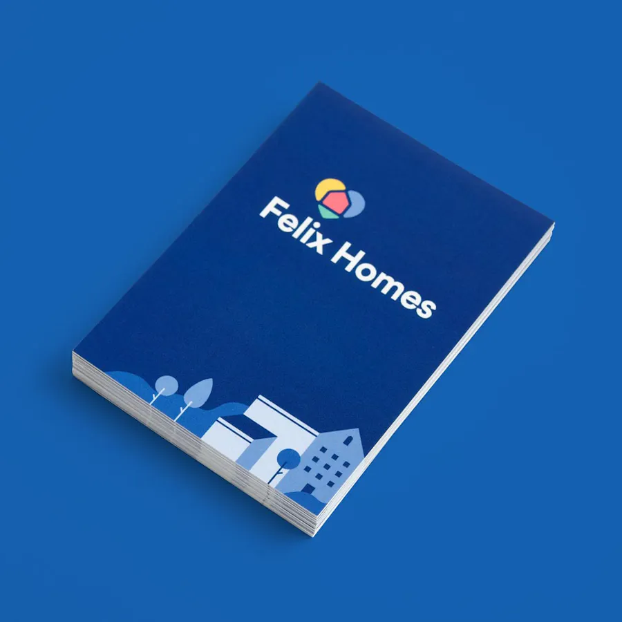 A stack of custom business cards with a blue design and Felix Homes in white letters.