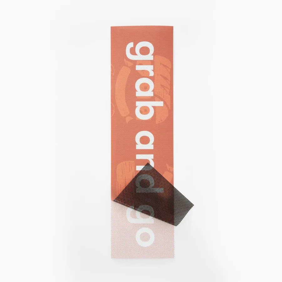 A perforated window decal printed with Grab and Go in white with an orange background.