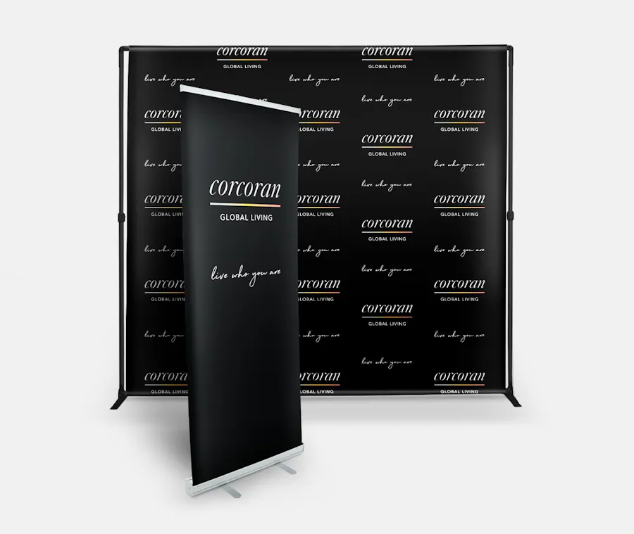 A retractable banner in front of a step and repeat banner with a creative print design in black.