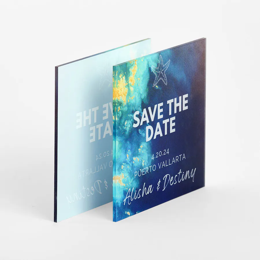 Two clear signs printed with Save the Date and a blue, green and yellow ocean design.