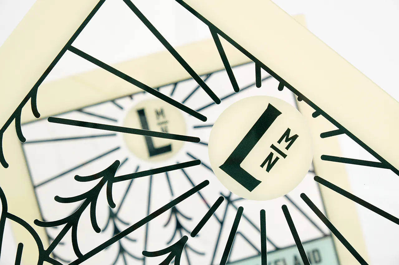 Custom clear signs printed with a forest design and LMN.