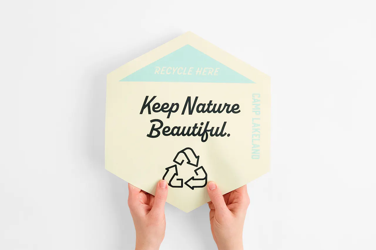 Two hands holding a custom floor graphic printed with Keep Nature Beautiful.