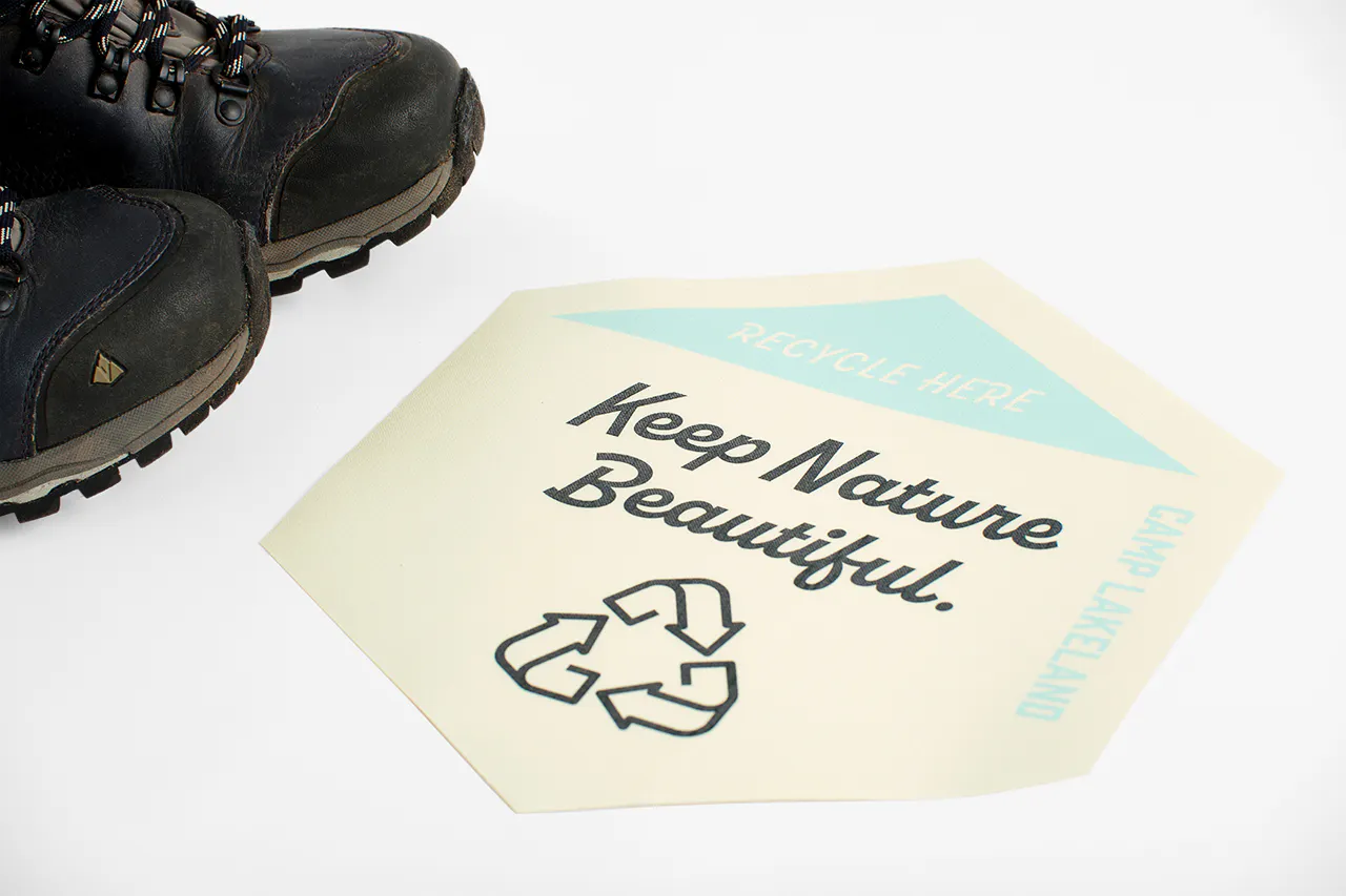 A foot next to a floor graphic printed with Keep Nature Beautiful.