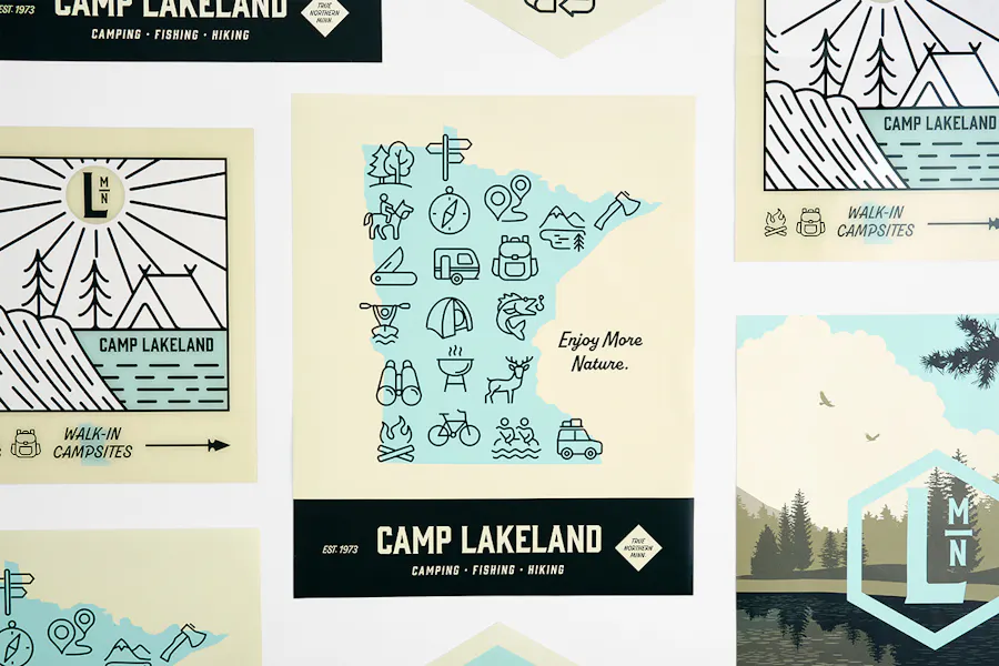 Custom posters lined up in rows with Camp Lakeland, a map of Minnesota and nature graphics.