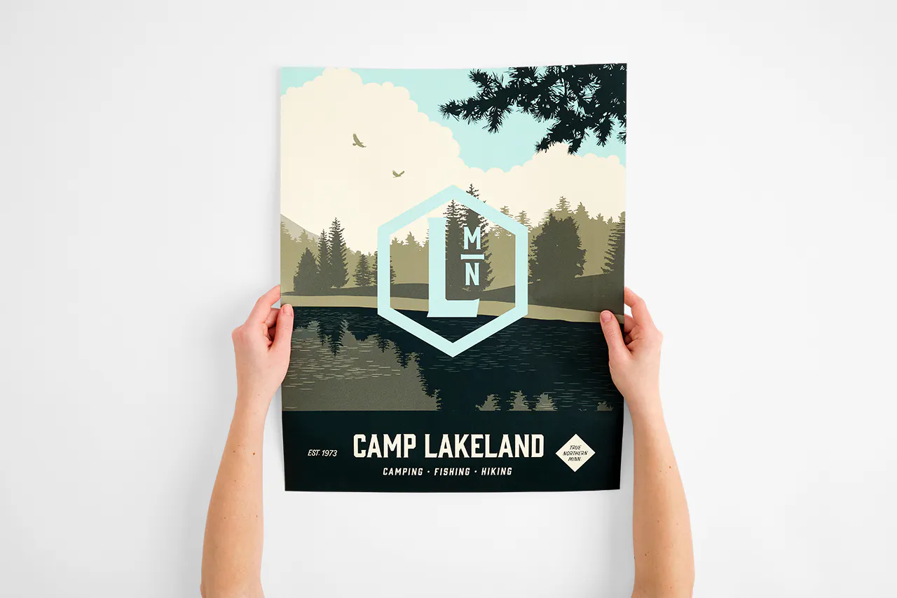 Two hands holding a wall decal printed with Camp Lakeland.