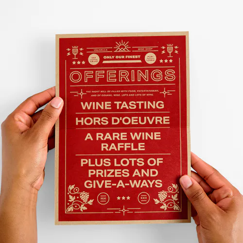 Two hands holding an invitation printed on Kraft paper with food and drink offerings.