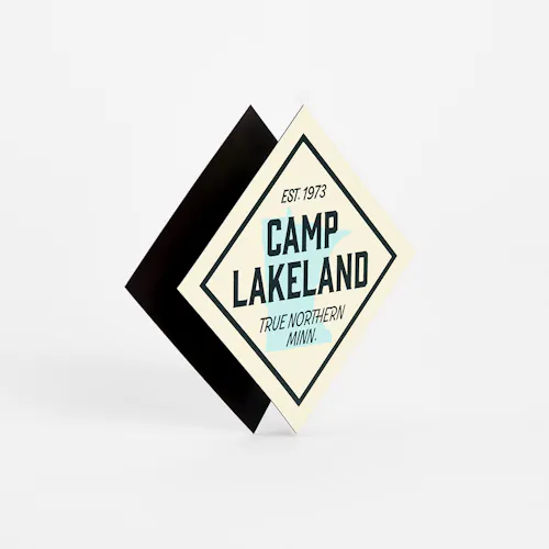 Two recycled magnets with a diamond shape printed with Camp Lakeland Est. 1973.