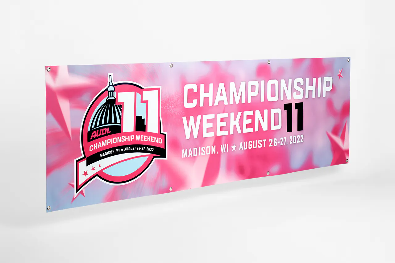 A hanging banner printed in blue, pink and white and AUDL Championship Weekend 11, Madison, WI, August 26-27, 2022.