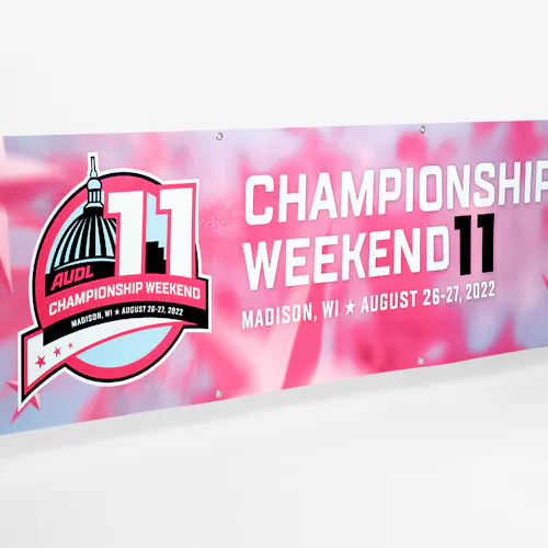 A hanging banner printed in blue, pink and white and AUDL Championship Weekend 11, Madison, WI, August 26-27, 2022.