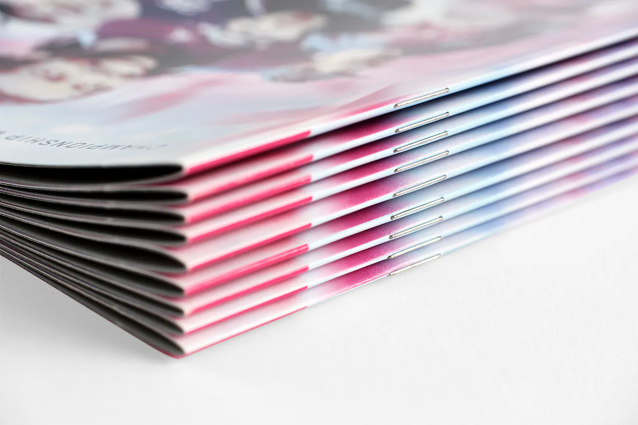 A stack of event programs with a saddle stitch binding printed for AUDL Championship Weekend 11.