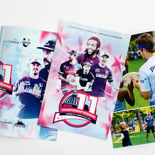 Three event programs for AULD Championship Weekend 11 printed with a saddle stitch binding and laying open to images of ultimate disc players.