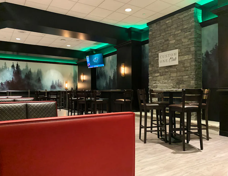 The Custom One Club, with booths and high-top tables, plus visual marketing throughout.