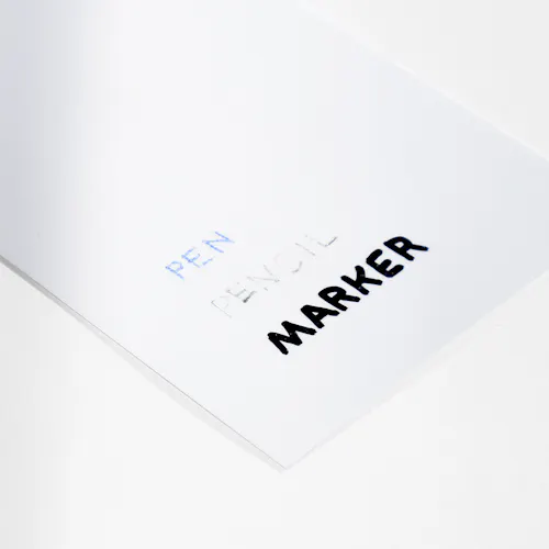 3 MIL GLOSS Paper stock with 3 mil gloss laminate and pen, pencil and marker written on it.