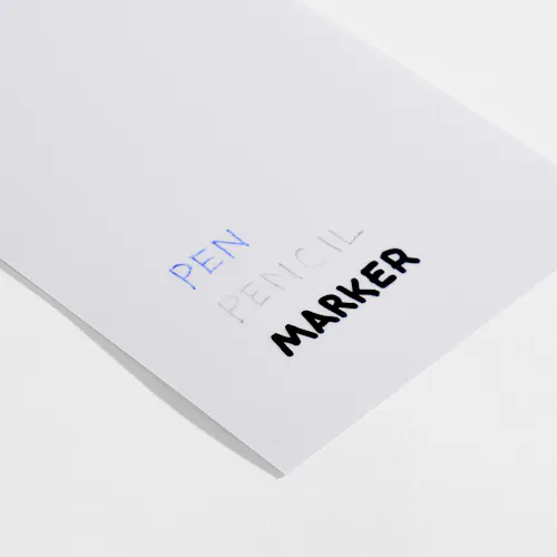 3 MIL MATTE Paper stock with 3 mil matte laminate and pen, pencil and marker written on it.