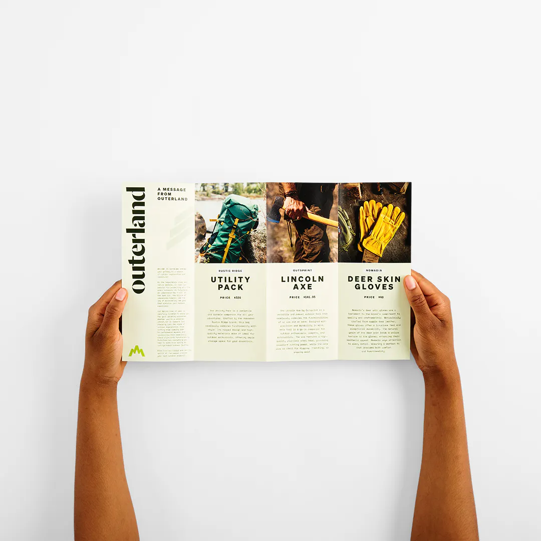Two hands holding open an accordion brochure with four panels printed with outdoor gear details.