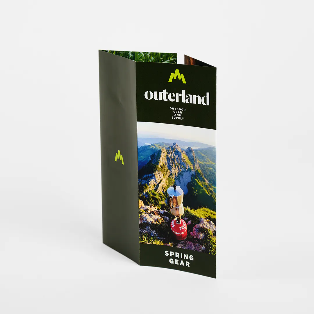 A closed gate fold brochure printed with Outerland Spring Gear on the front.