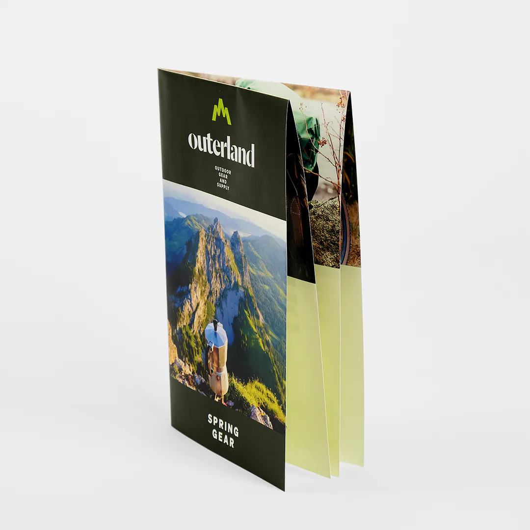 A French fold brochure standing and printed with Outerland Spring Gear on the front.