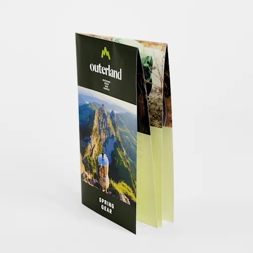 A French fold brochure standing and printed with Outerland Spring Gear on the front.
