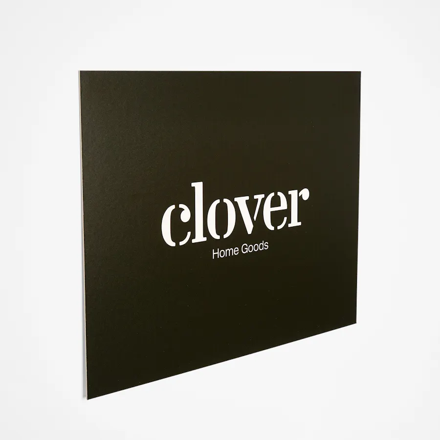 A custom sign printed on eco-friendly material with a black background and Clover in white.