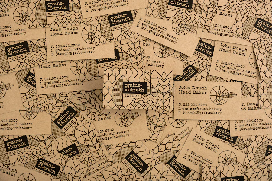 A pile of scattered business cards printed on Kraft paper with Grain of Truth in black.