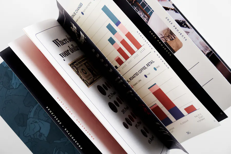 A perfect bound booklet laying open with its pages turning and printed with charts and graphs for MoonGoat Coffee.