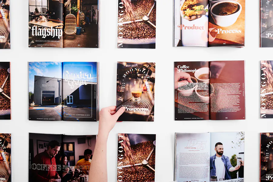 Three rows of perfect bound booklets printed with info about and images of MoonGoat Coffee Roasters.