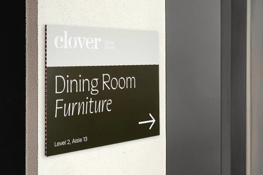 A business sign printed on FSC honeycomb with Clover Home Goods and Dining Room Furniture.