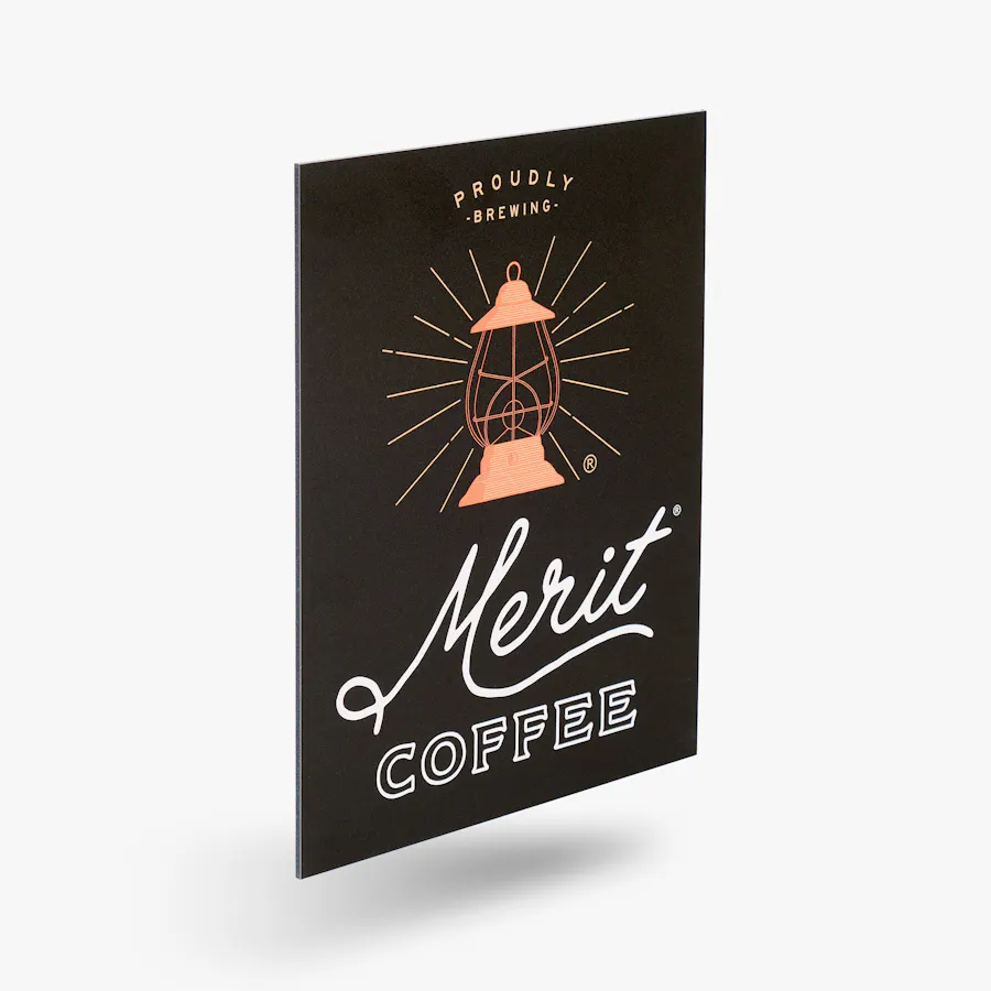 A custom aluminum sign printed with Merit Coffee and a lantern design in orange.