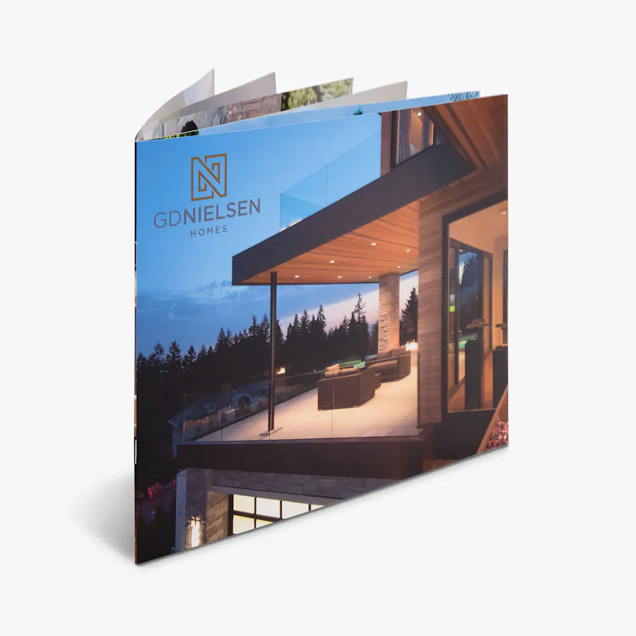 A real estate booklet printed with GDNielson Homes and an image of a modern home on the cover.