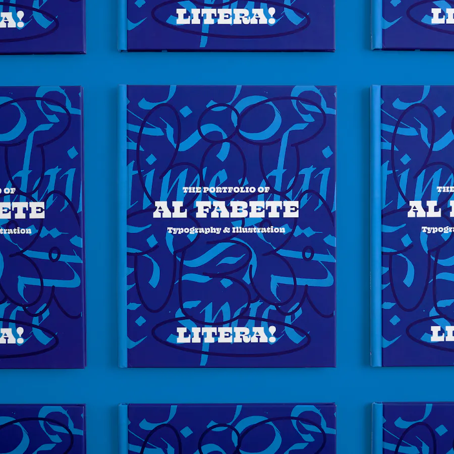 Custom booklets lined up in three rows and printed with The Portfolio of Al Fabete in white.