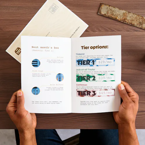 Subscription-Based Catalog Two hands holding a direct mail catalog printed with subscription box information.