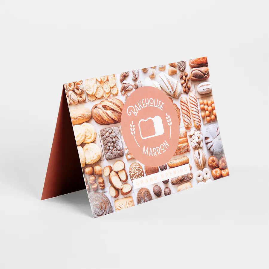 A folded self-mailer printed with Bakehouse Marron and images of bread with Mocha Mousse accents.