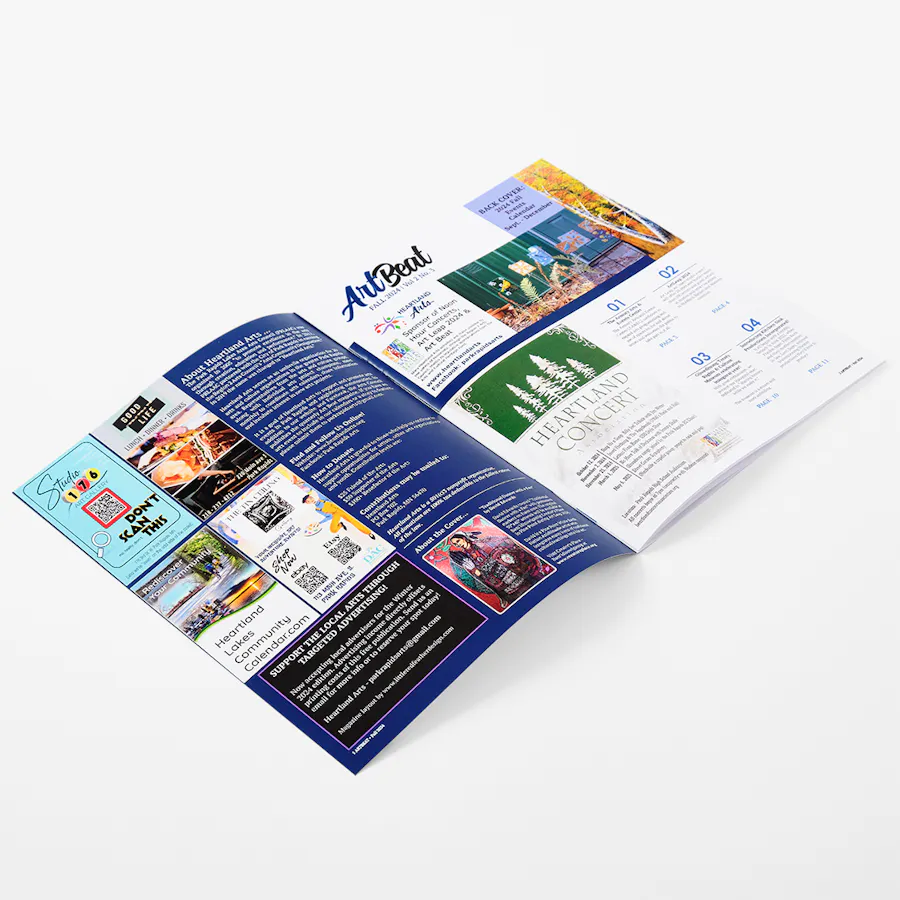 A custom magazine laying open to information and imagery about local art events and projects.