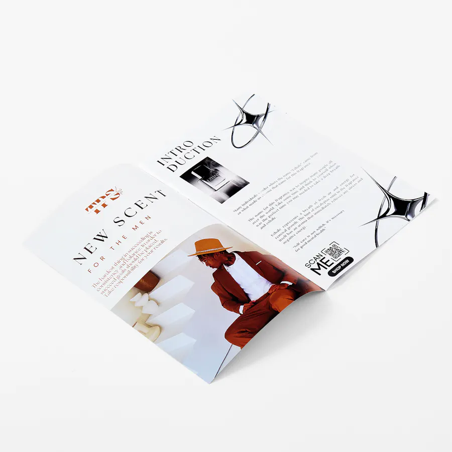A fragrance magazine laying open and printed with scent information and branded imagery.