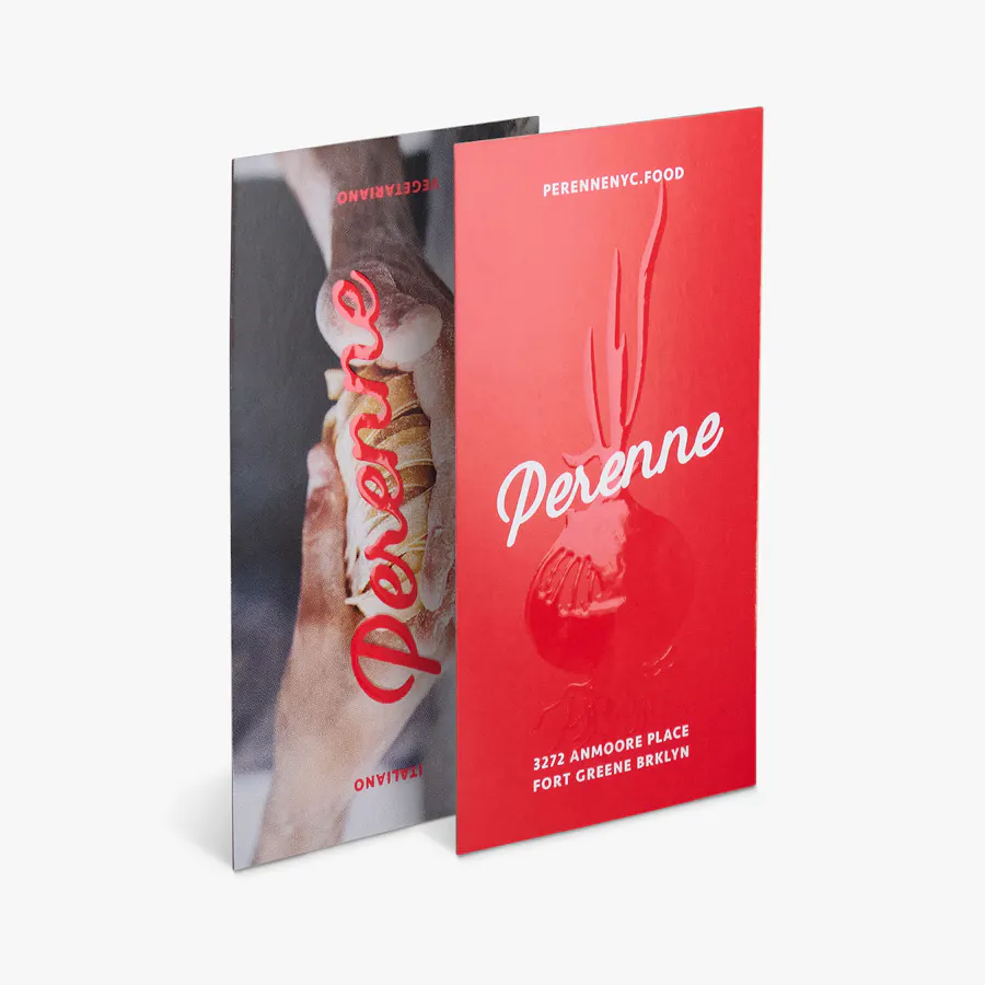Two business cards overlapping each other and printed with a raised spot UV finish.