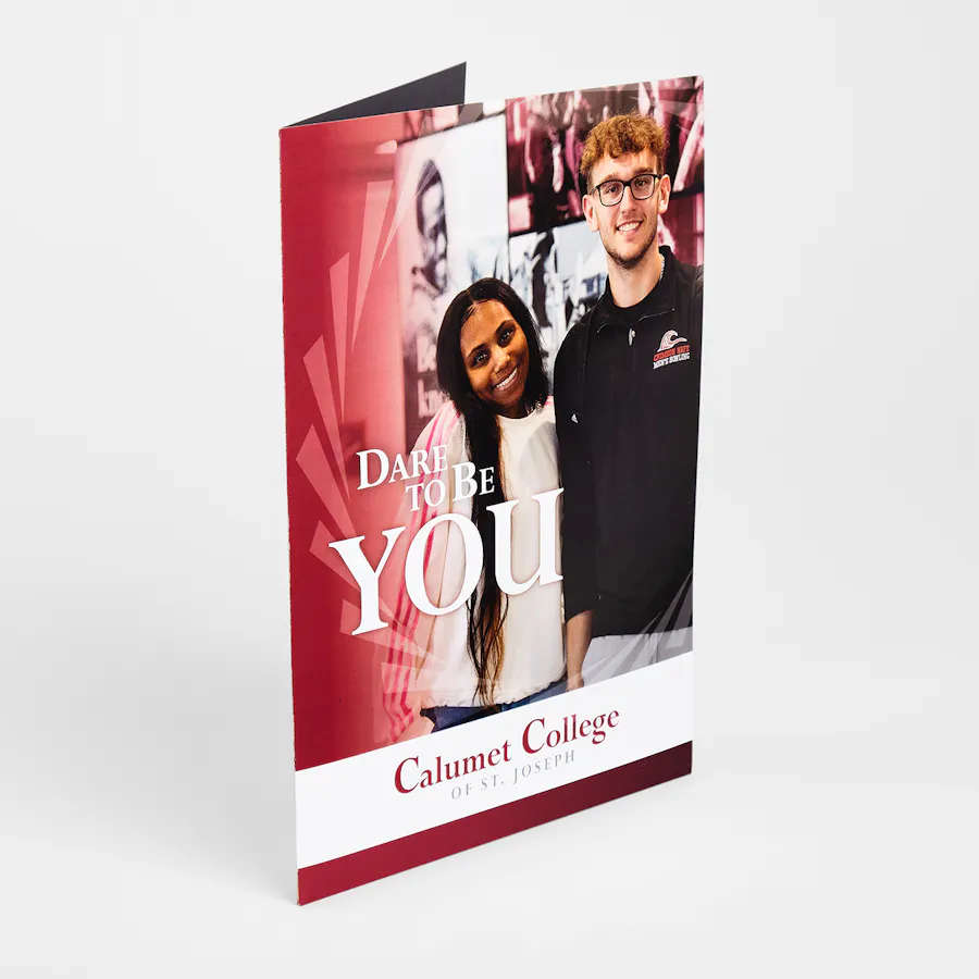 A college pocket folder printed with two smiling students on the cover.