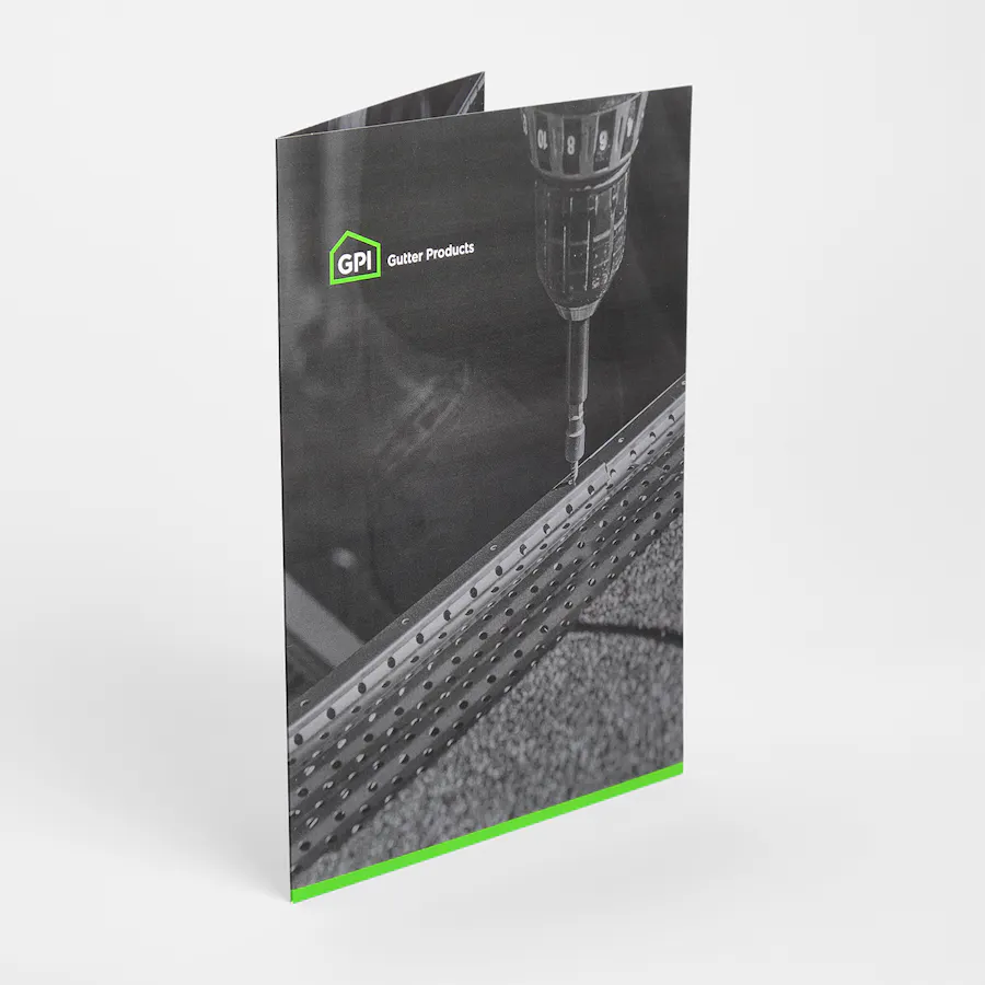 A presentation folder standing open and printed with a Gutter Products design in black and green.