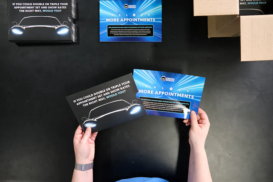 Two hands holding two print marketing materials printed with messaging for Phone Ninjas.