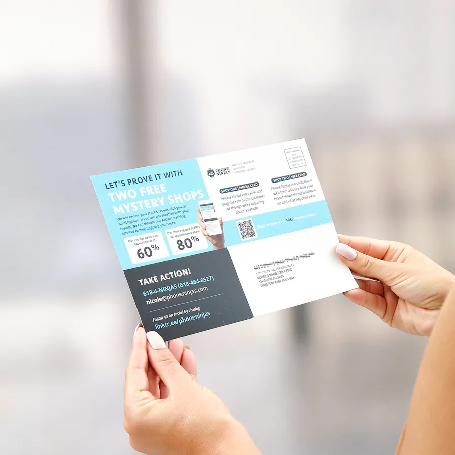 Two hands holding a print marketing postcard printed with info about sales coaching.