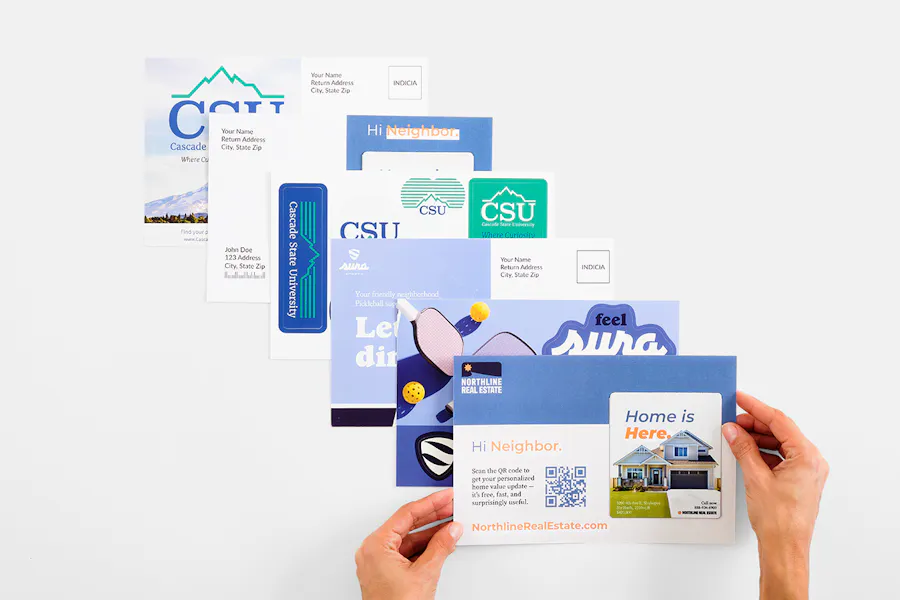 Six magnet postcards and sticker postcards fanned out with two hands holding the last one.