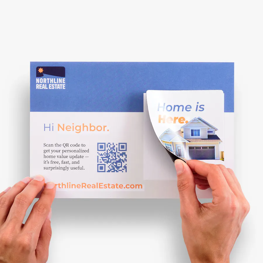 Two hands peeling a magnet off of a custom postcard with real estate branding.