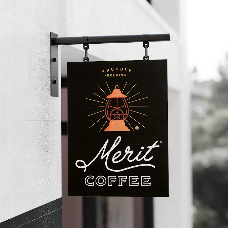An aluminum sign printed with Merit Coffee and a lantern graphic in orange.