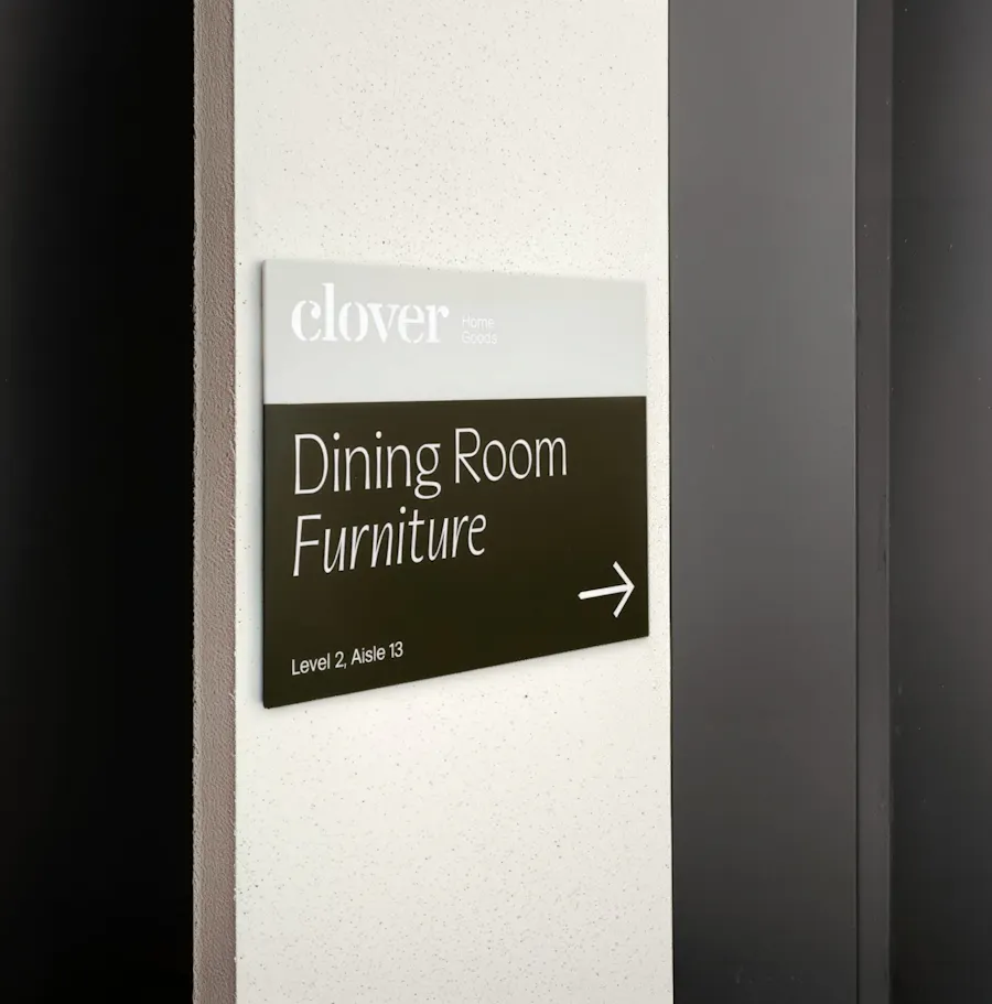A foam board sign printed with Dining Room Furniture in white and an arrow pointing to the right.