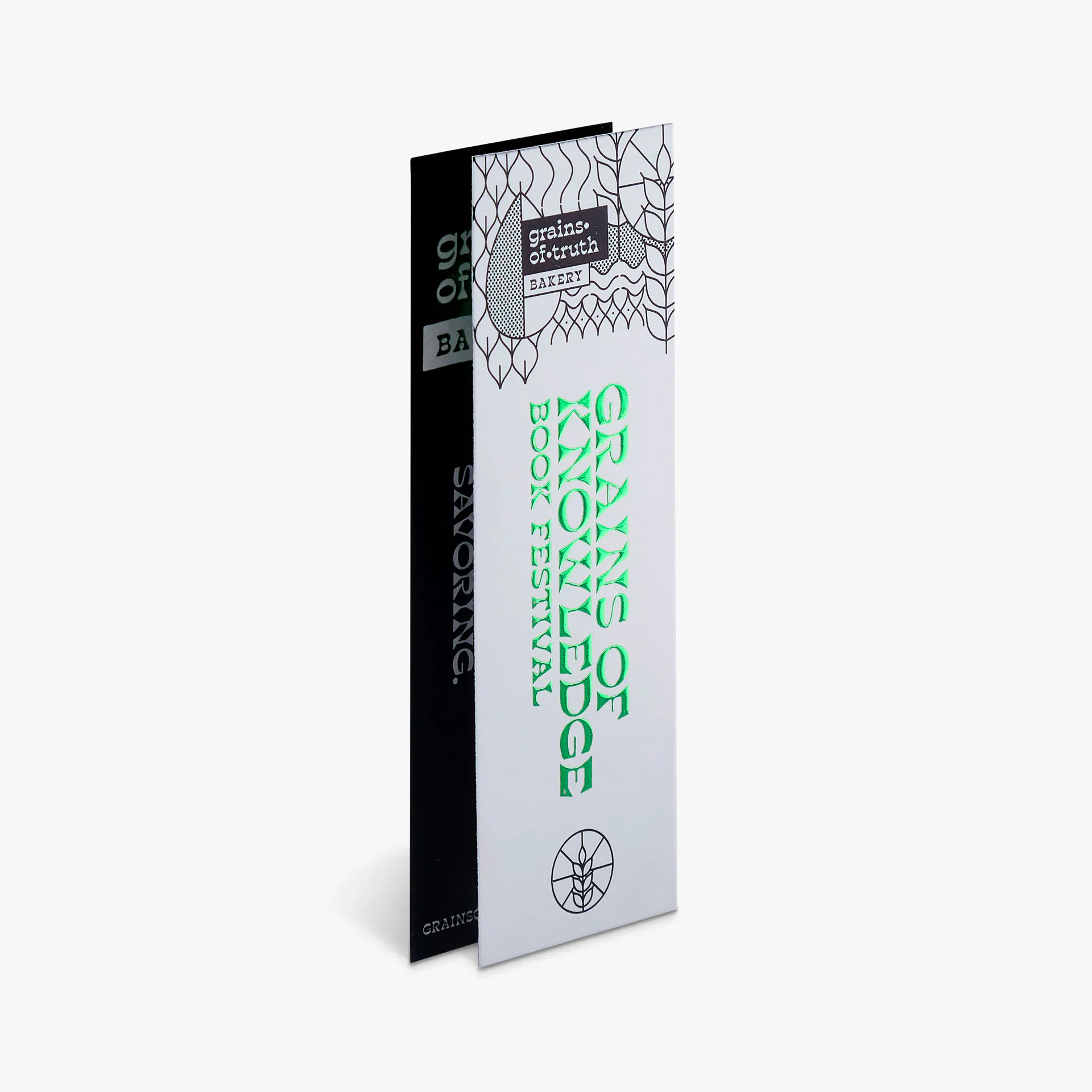 Two custom bookmarks printed with a black and white design and green raised foil.